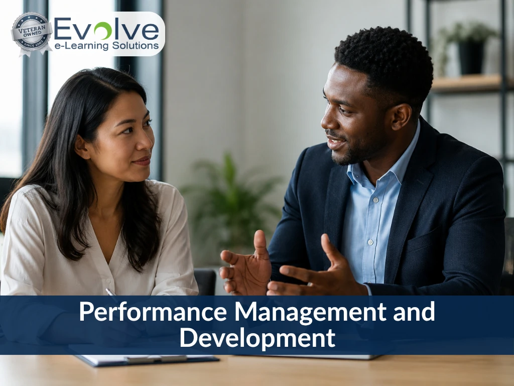 Two colleagues discussing workplace topics, with text overlay reading Performance Management and Development by Evolve e-Learning Solutions