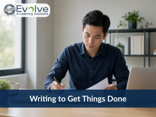 Man writing at a desk next to a laptop. Evolve e-Learning Solutions: Writing to Get Things Done